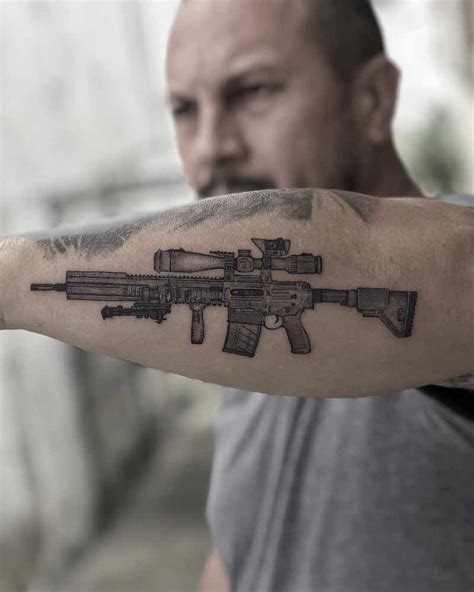 Details 70+ gun tattoo on arm super hot - in.coedo.com.vn