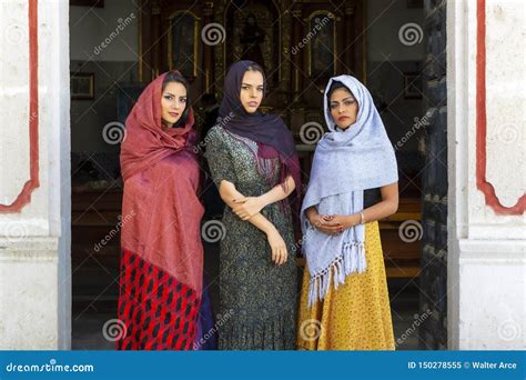 Three Lovely Hispanic Brunette Models Pose In A Catholic Church Stock
