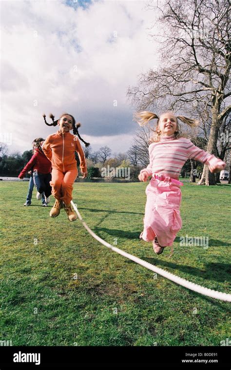 Teacher and school children playing Stock Photo - Alamy