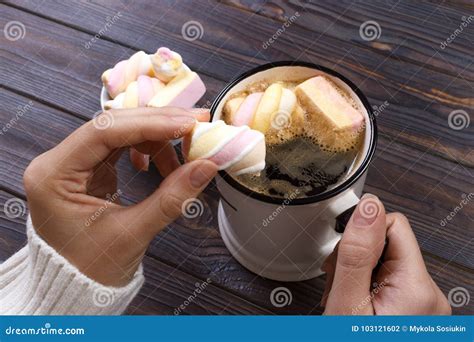Female Hand Holding Cup Of Hot Cocoa Or Chocolate With Marshmallow On