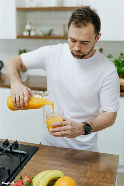 Man Pouring Orange Juice Into A Glass Premium Image By Rawpixel