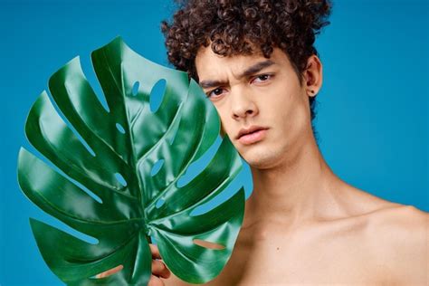 Premium Photo Man With Curly Hair Naked Shoulders Green Leaves Ecology