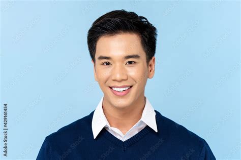 Close Up Portrait Of Young Handsome Smiling Asian Man Face On Light