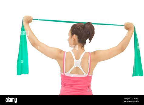 Rear View Of Sporty Brunette Stretching With Resistance Band Stock