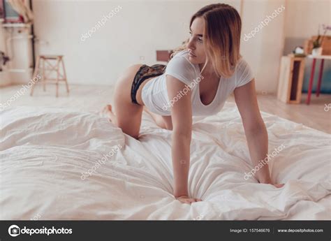 Sexy Blonde Woman In A White T Shirt And Panties On The Bed Stock Photo By Airkost