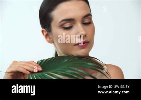 Beautiful Naked Woman Holding Leaf Of Tropical Plant On Grey Background Stock Video Footage Alamy