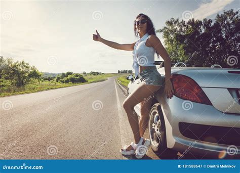 Beautiful Woman Hitchhiking By A Broken Car Beautiful Young Girl In Short Shorts Stands At Her