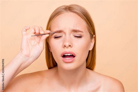 Patient Pretty Nude Natural Model With Close Eyes Plucking Eyebrows With Tweezers Having