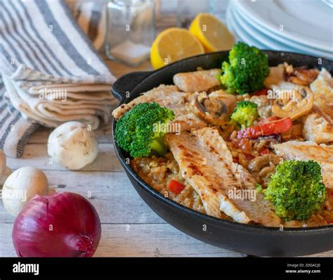 Fish With Brown Rice And Vegetables Stock Photo Alamy