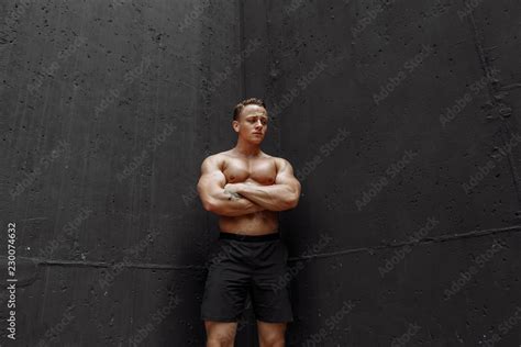 Strong And Muscular Bodybuilder With Blonde Shrt Haircut And Naked Muscular Torso Showing His