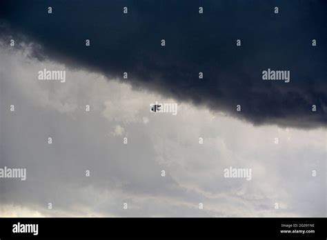 A Raven Flies Beneath Dark Rain Clouds In Santa Fe New Mexico Stock