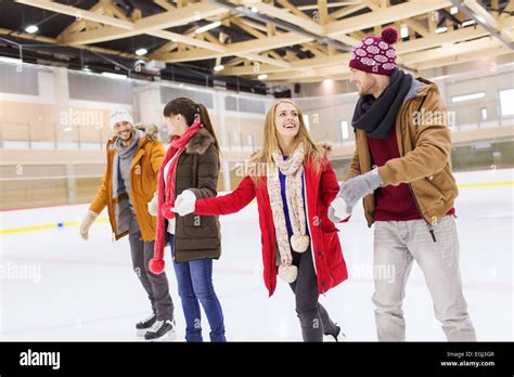 Happy Friends On Skating Rink Stock Photo Alamy