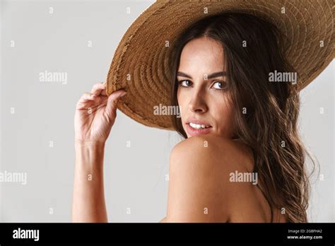 Sensual Half Naked Girl In Straw Hat Posing And Looking At Camera