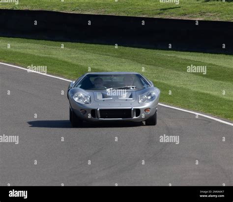 A Green 1958 Jaguar Saloon Leads A Ford Gt40 At The 2022 Goodwood