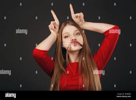 Jeune femme blanche blonde fraîche qui fait de la moustache avec ses cheveux Belle adolescente