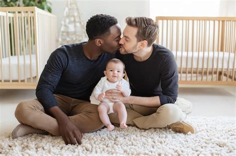 Gay Dads Kissing While Holding Their Baby Premium AI Generated Image