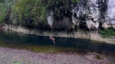 Cute Asian Girl In Bikini Playing And Waiving On A Rope In The River Thailand Drone Stock