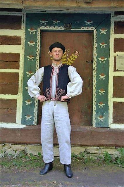 a man standing in front of a wooden building