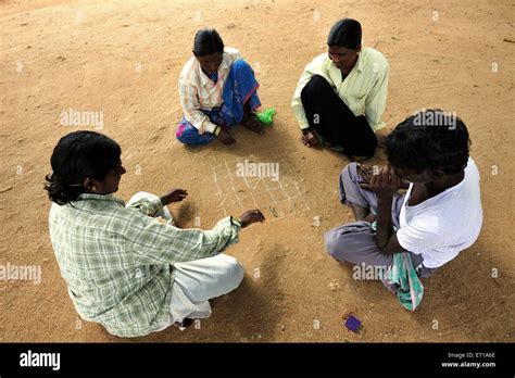 rural people playing board game  sand hampi karnataka india asia