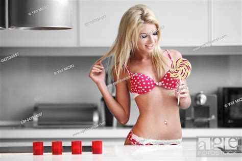 Sexy Blonde Woman In Lingerie Posing With Lollipop Stock Photo