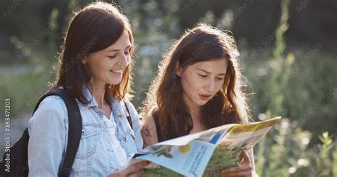 Two Pretty Brunette Women Exploring The Way Using Map Girls Travel And