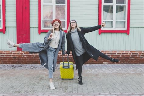 Premium Photo Two Cheerful Funny Tourist Women Smiling And Fool