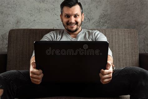 A Man Watches An Adult Video On A Laptop While Sitting On The Couch The Concept Of Porn Men S