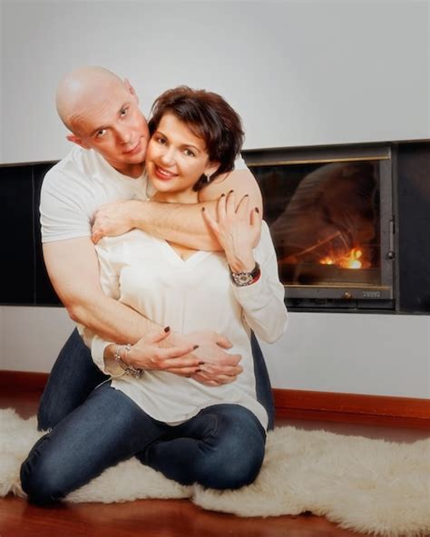 Premium Photo Romantic Couple Of Brunette Woman And Bald Headed Man Sitting On The Fur Carpet