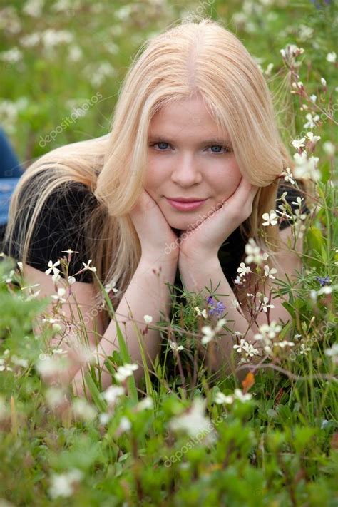 Beautiful Blonde Girl Surrounded By Flowers Stock Photo By Gelpi