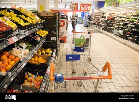 A Trolleys And Shoppers In The Fruit And Veg Aisle Sainsburys