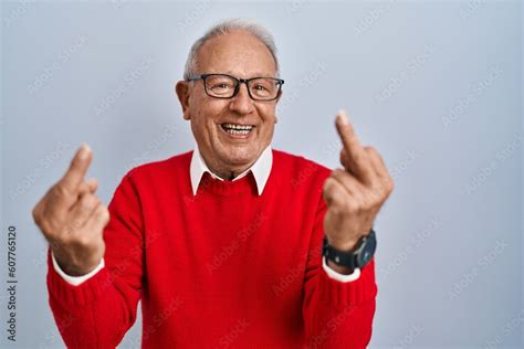 Senior Man With Grey Hair Standing Over Isolated Background Showing Middle Finger Doing Fuck You
