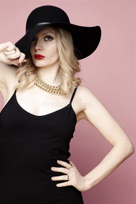 Blonde In A Black Latex Suit Put Her Foot On The Wall In A Pose Stock Photo Image Of Fetish