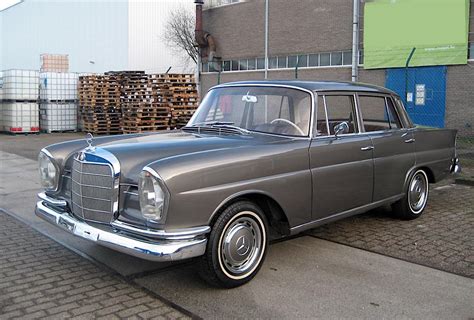 An Old Car Is Parked On The Side Of The Road