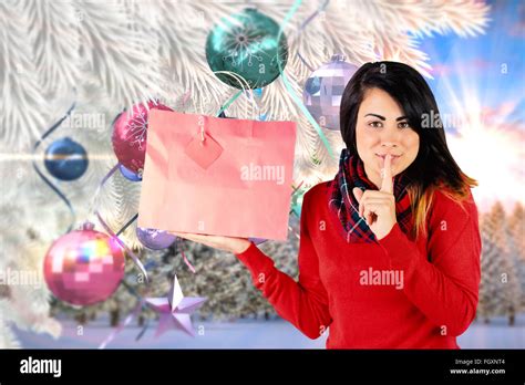 Composite Image Of Brunette Holding Gift Bag And Keeping A Secret Stock