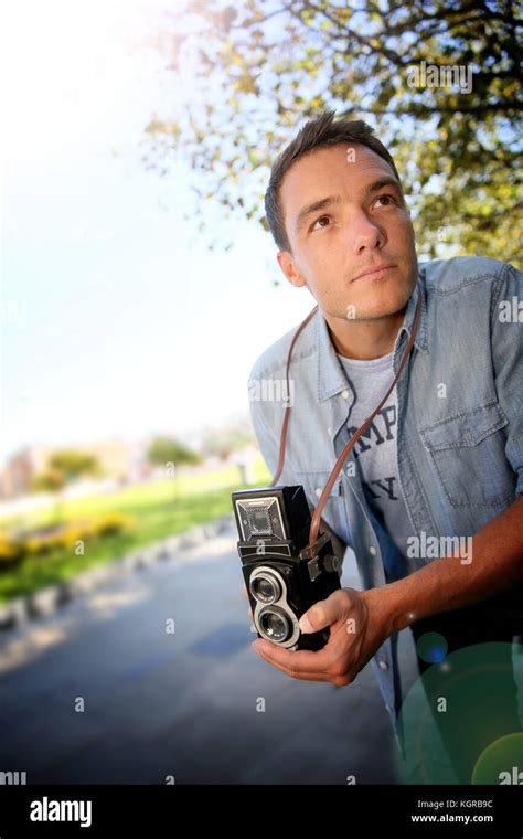 Photographer using vintage camera Stock Photo - Alamy