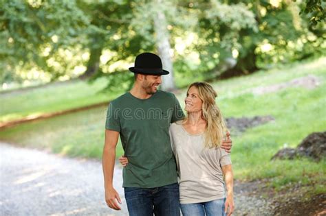Loving Every Minute Together A Young Couple Walking Arm In Arm In A