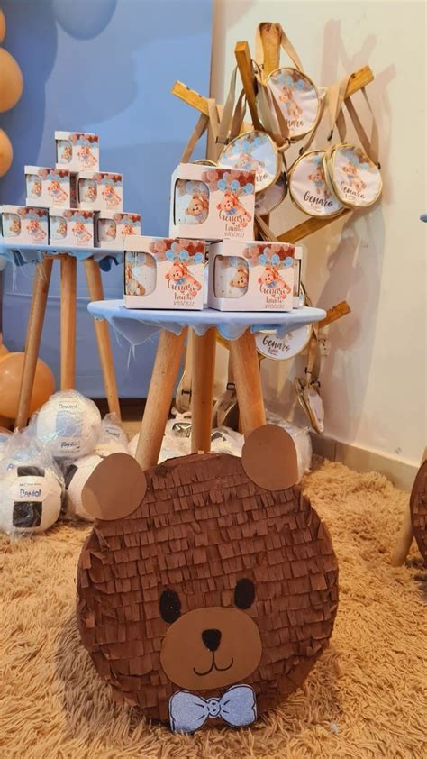 A Teddy Bear Sitting On The Floor In Front Of Some Decorations