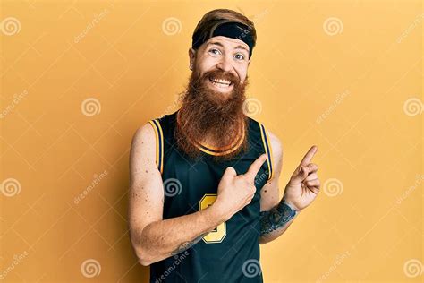 Redhead Man With Long Beard Wearing Basketball Uniform Smiling And