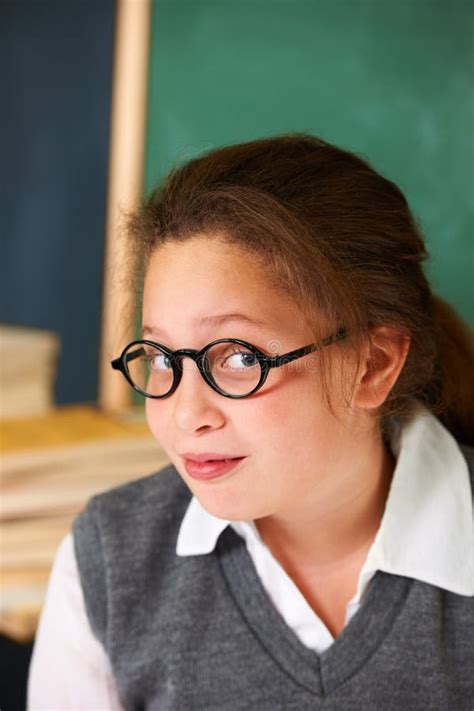 Shes A Smart Student Portrait Of A Cute Brunette Girl In The Classroom Stock Photo Image Of