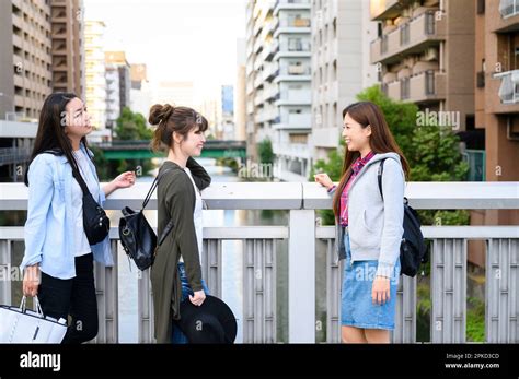 3 female travelers saying goodbye to each other Stock Photo - Alamy