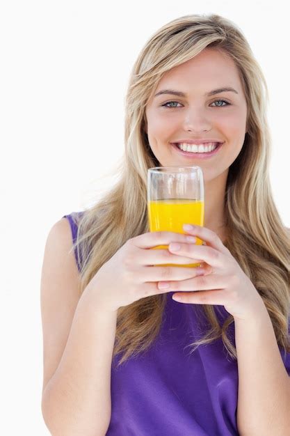 Premium Photo Smiling Blonde Woman Holding An Orange Juice