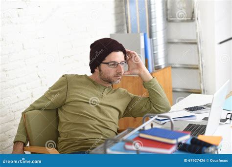 Young Attractive Hipster Businessman Working From His Home Office As