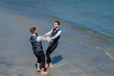 Premium Photo Gay Grooms Walking Together On Sea Beach During Wedding Day Romantic Men In Sea