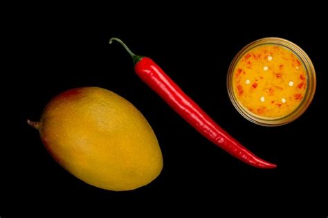 Premium Photo Mango Chili Sauce Ripe Mango And Red Hot Pepper Isolated On Black Top View