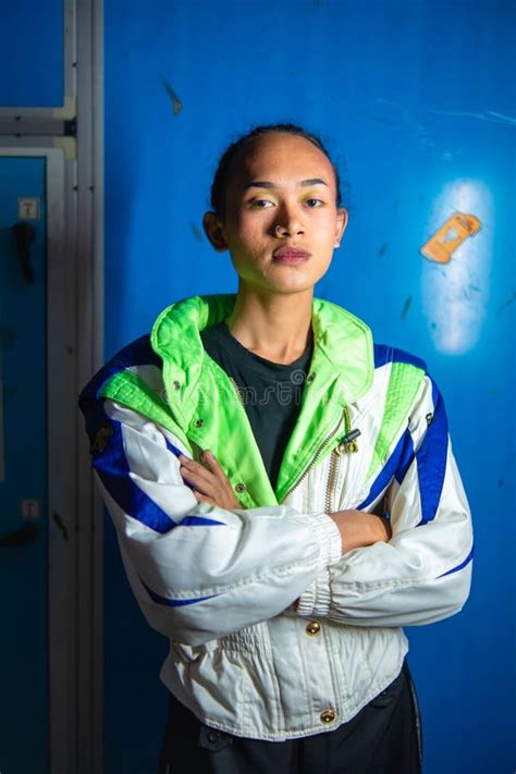 A Gay Asian Man Posing In A Tracksuit In Front Of A Blue Locker Stock Image Image Of Isolated