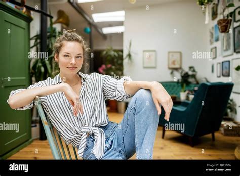 Young Woman Sitting Relaxed On Chair Stock Photo Alamy