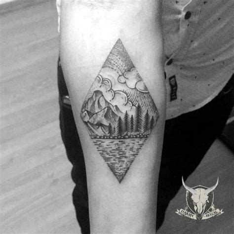 A Black And White Photo Of A Man S Arm With A Mountain Tattoo On It