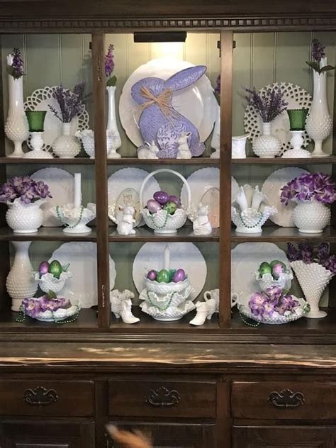 A China Cabinet Filled With Dishes And Vases On Top Of Wooden Shelves