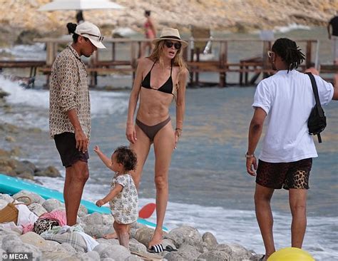 Doutzen Kroes Displays Her Washboard Abs In Black Bikini As She Enjoys
