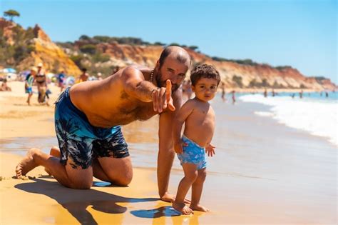 Premium Photo Father Playing In The Sand Praia Do Barranco Das